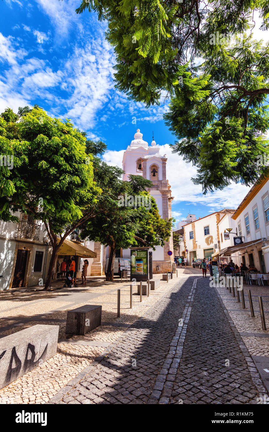 Overlooking the cobbled street and church in the town of Burgau, Algarve region, Portugal Stock Photo