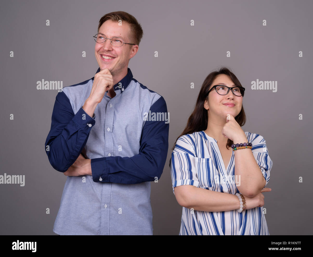 Portrait of happy multi ethnic diverse couple thinking Stock Photo