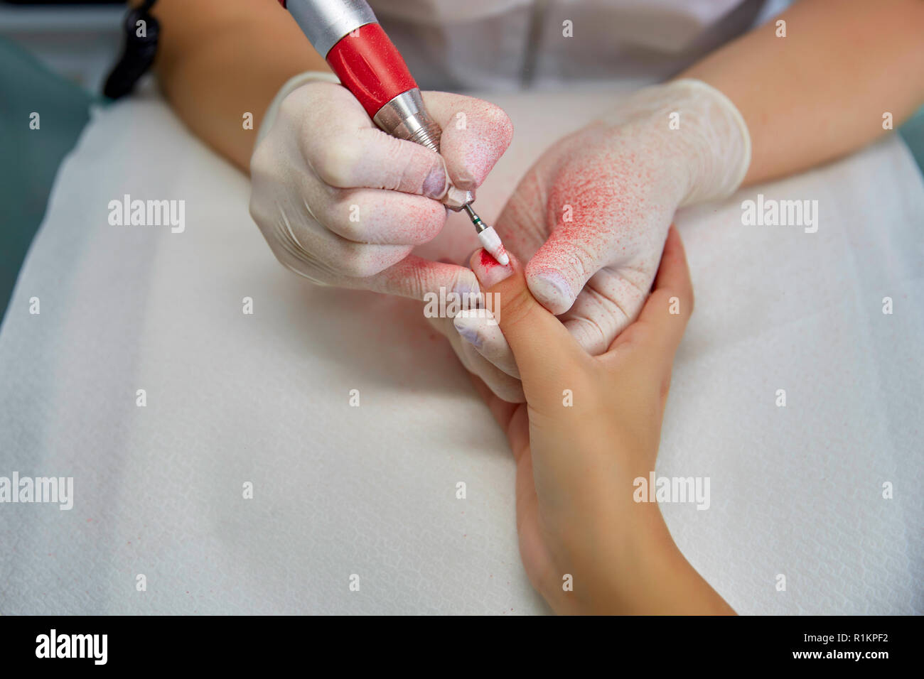 Sawing nails removing manicure, professional work in the beauty salon Stock Photo