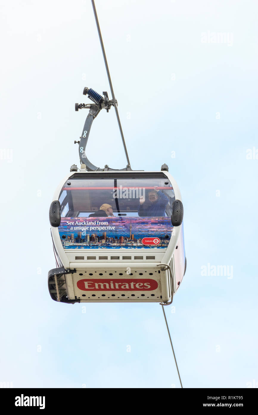 Two passengers, one waving, on the Emirates cablecar across the River Thames at North Greenwith, London, UK Stock Photo