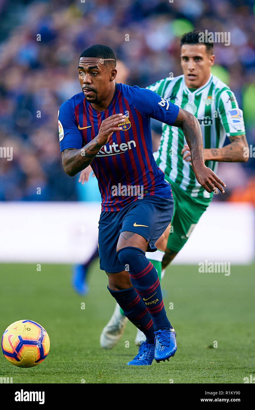 Barcelona Spain November 11 Malcom Filipe Silva De Oliveira L Of Fc Barcelona Competes For The Ball With Cristian Tello Herrera Of Real Betis Balompie During The La Liga Match Between
