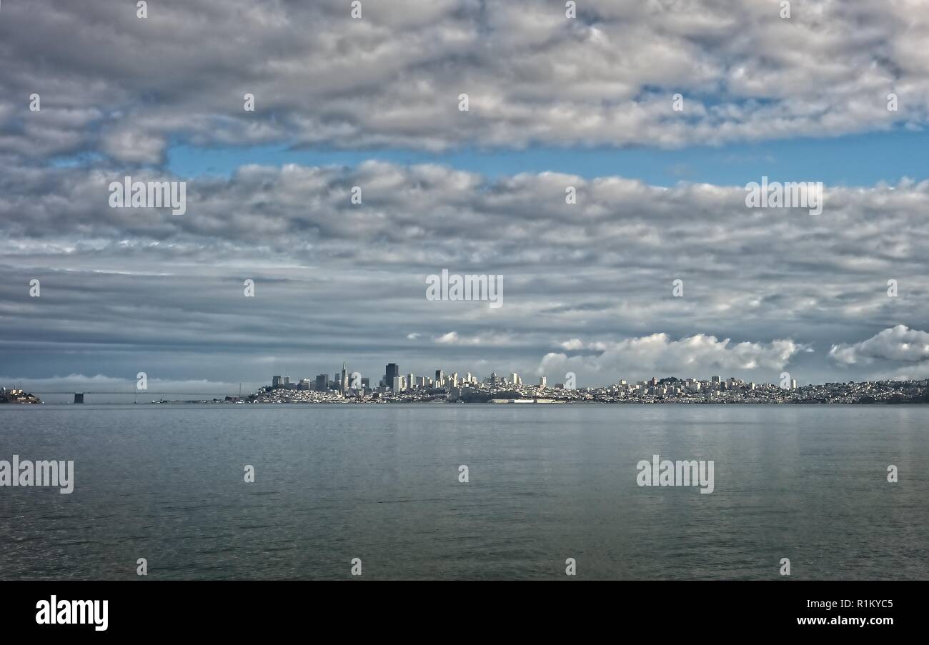 San Francisco skyline from the San Francisco Bay with a cloudy sky Stock Photo