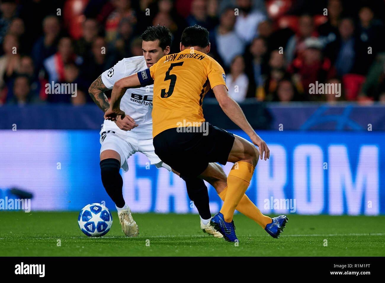 VALENCIA, SPAIN - NOVEMBER 07: Santi Mina of Valencia CF competes for the ball with Steve von Bergen of BSC Young Boys during the Group H match of the UEFA Champions League between Valencia and BSC Young Boys at Estadio Mestalla on November 7, 2018 in Valencia, Spain. (David Aliaga/MB Media) Stock Photo
