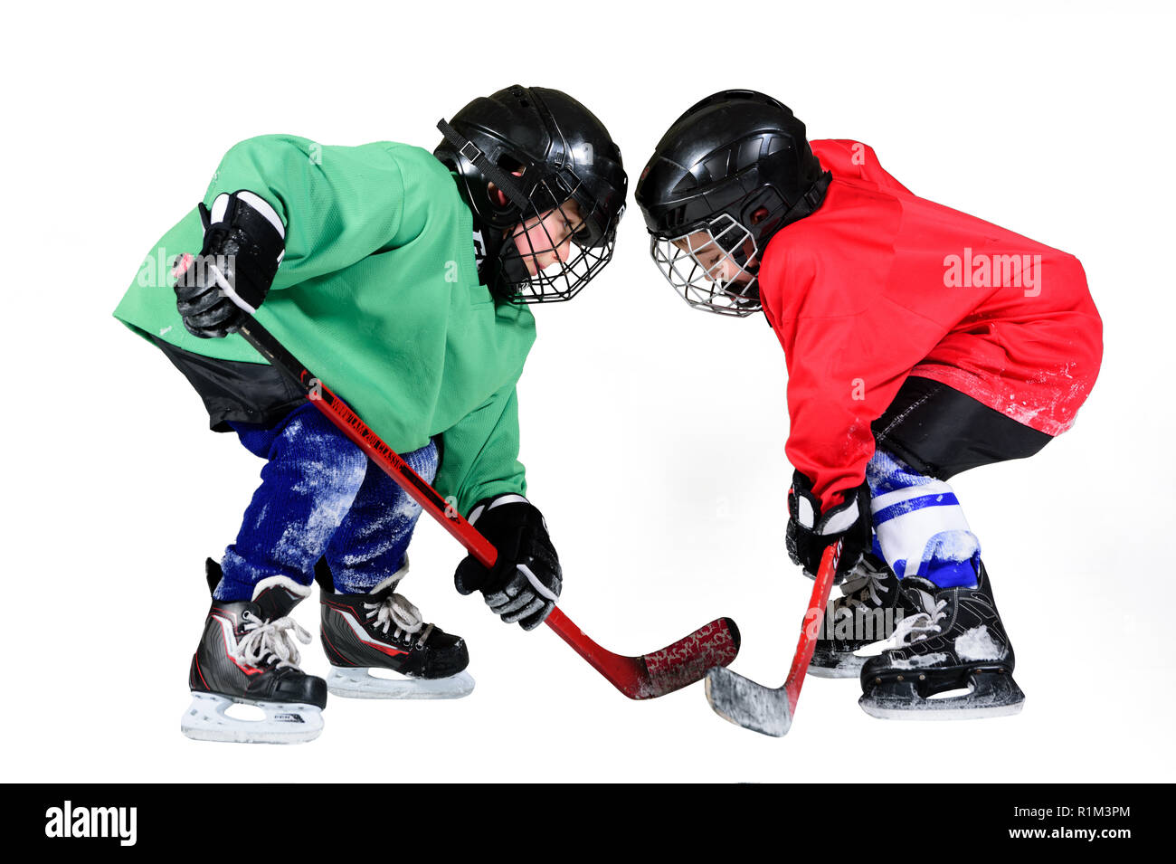 Boy playing ice hockey. Little hockey player isolated on white