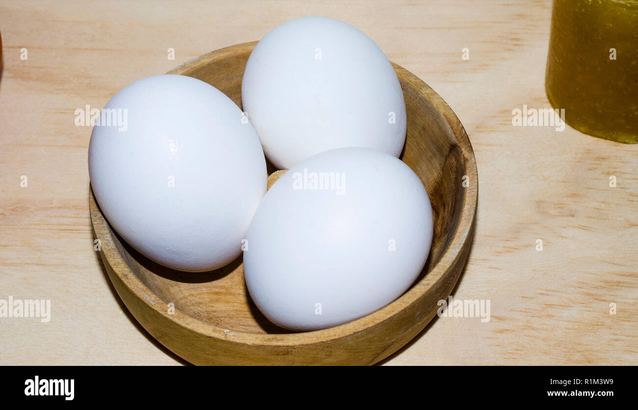 dish with three white eggs Stock Photo