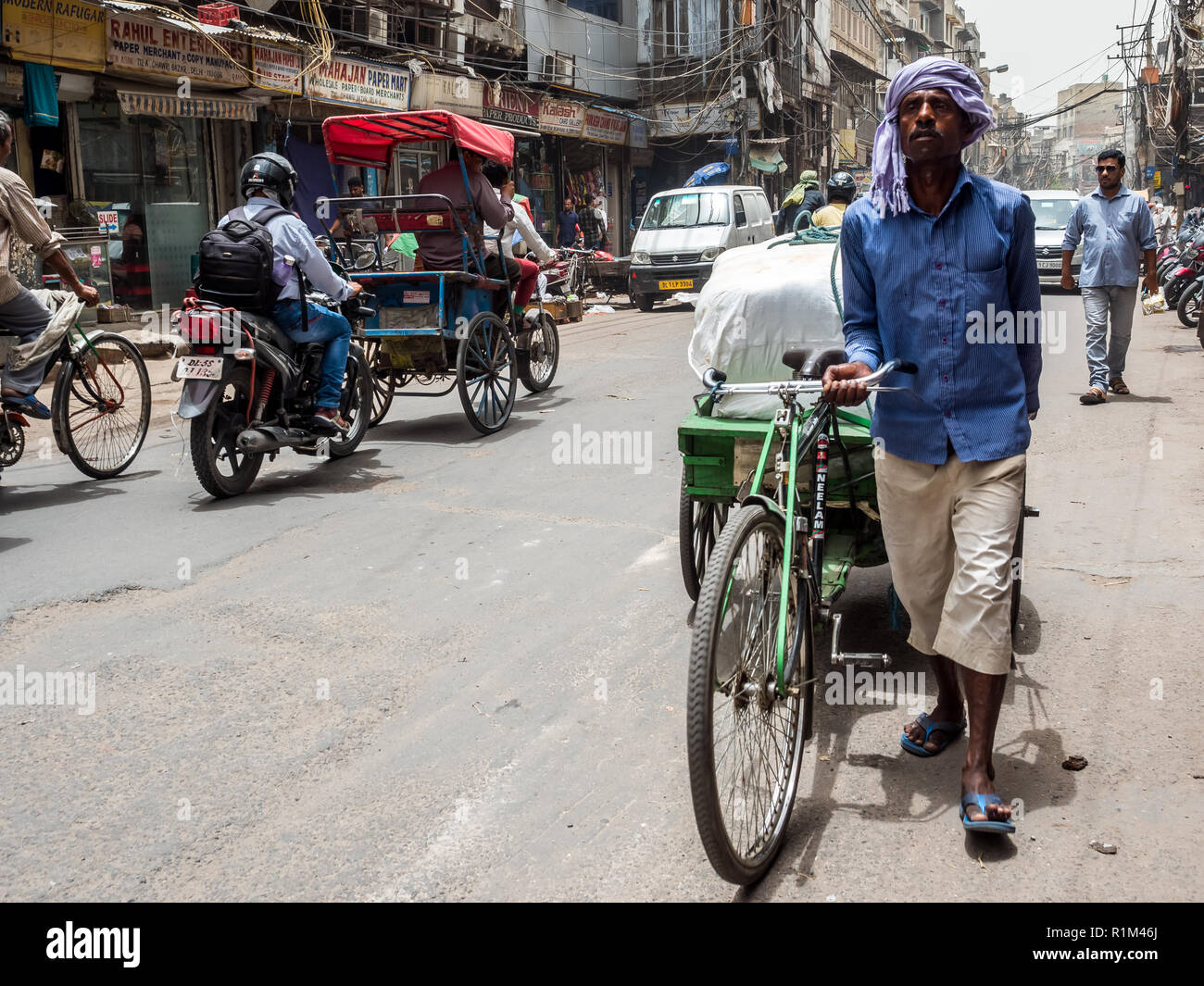 A man walking and driving a rickshaw. Old Delhi. India 2018 Stock Photo