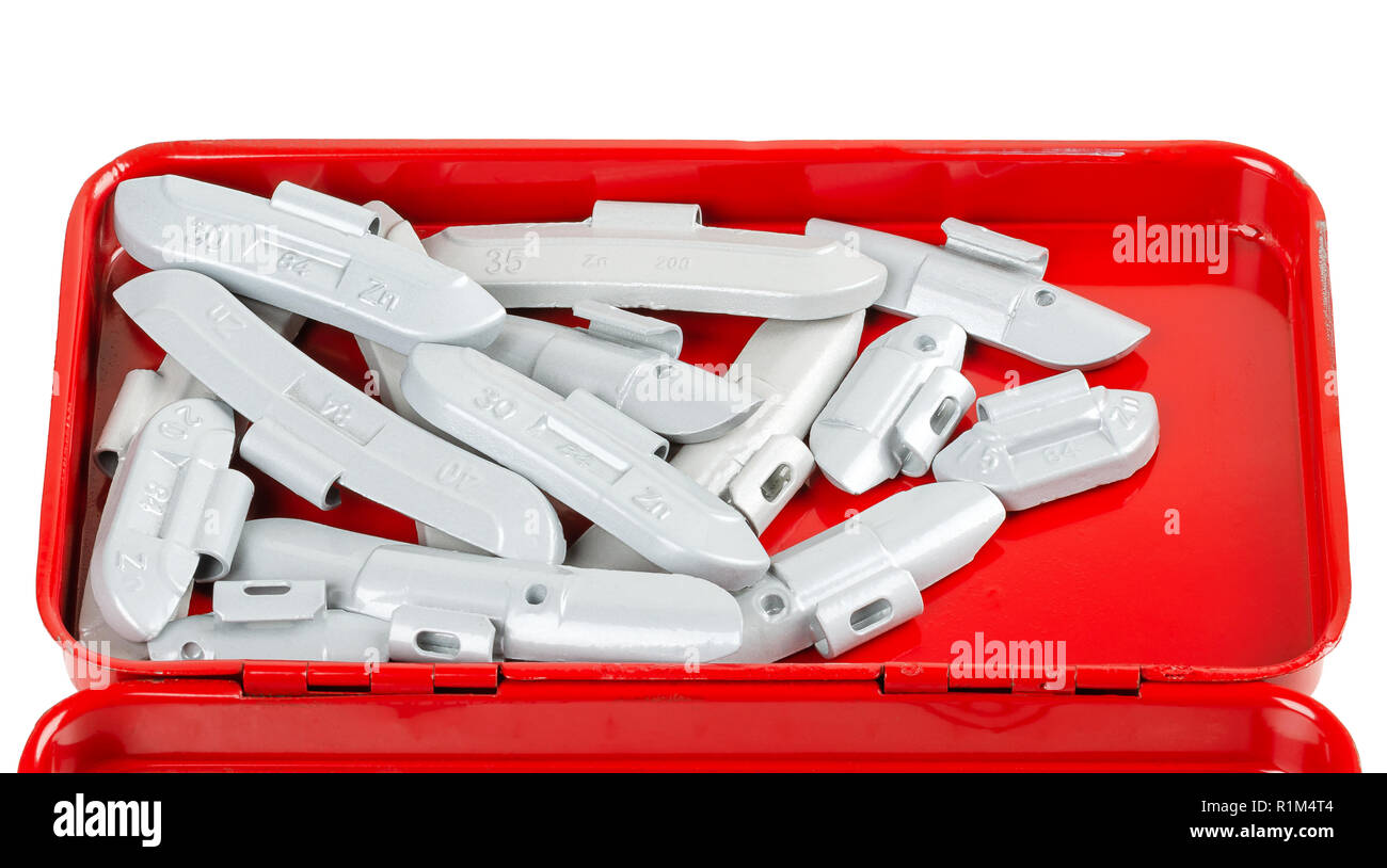 Clip-on zinc tire weights in red tool box. Correction wheel weights, to mount on the rims to create a better mass distribution and balance. Lead free. Stock Photo
