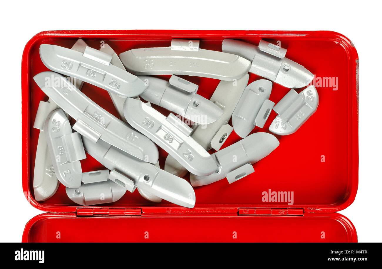 Clip-on zinc tire weights in red tool box from above. Correction wheel weights, to mount on the rims to create a better mass distribution and balance. Stock Photo