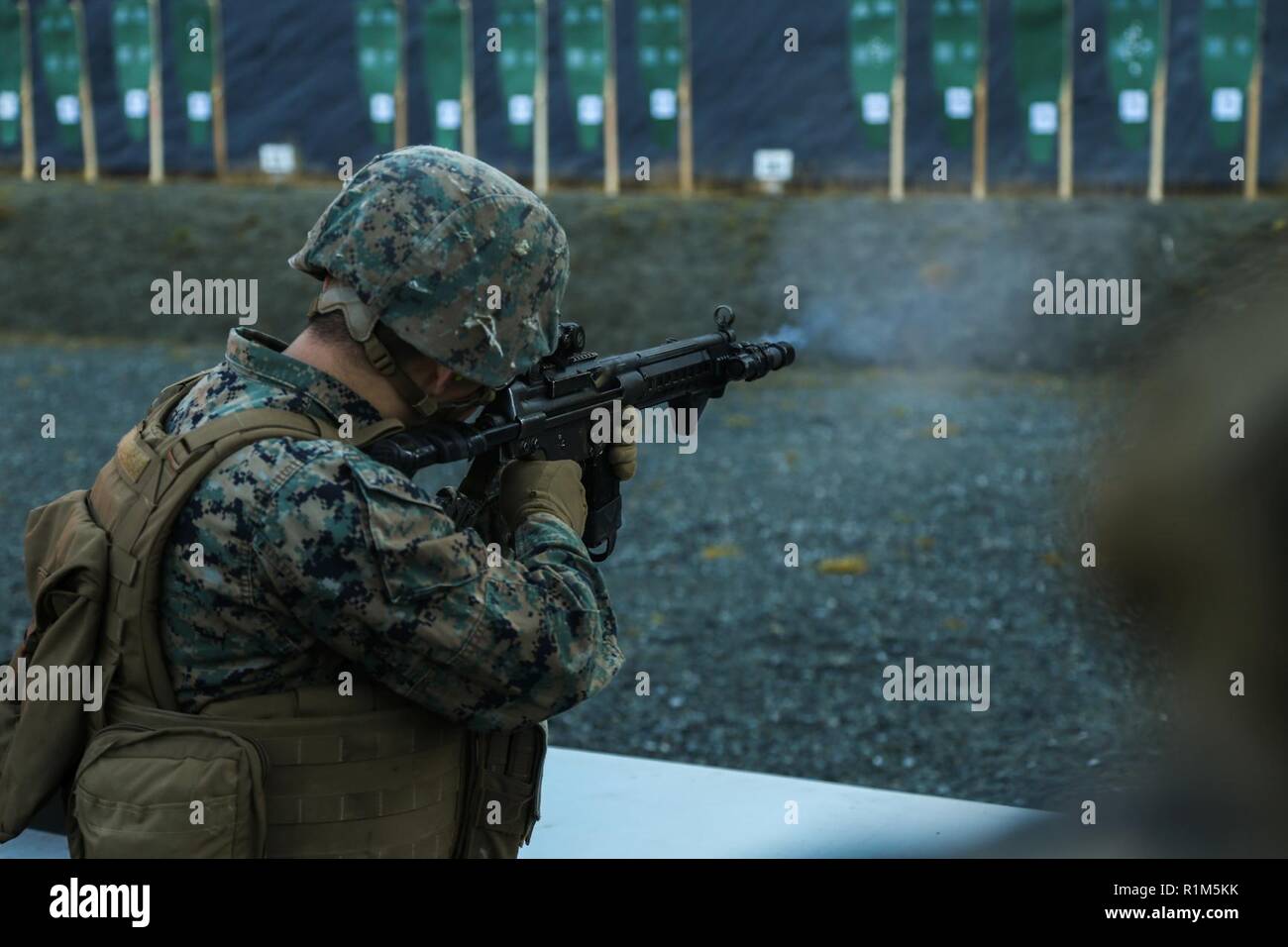 U.S. Marine Corps Lance Cpl. Sayfullakhuji Nurullakhonov, with 2nd Marine Logistics Group-Forward, fires a Norwegian AG-3 battle rifle with the Norwegian Home Guard during Exercise Trident Juncture 18 in Hell, Norway, Oct. 12, 2018. The Norwegians trained U.S. Marines on the familiarization of different rifles used by the Norwegians to enhance the U.S. and NATO Allies' and partners' ability to work together collectively to conduct military operations under challenging conditions. Stock Photo