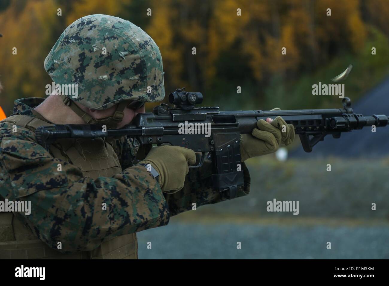 U.S. Marine Corps Sgt. Brian Daly, with 2nd Marine Logistics Group-Forward, fires a Norwegian AG-3 battle rifle with the Norwegian Home Guard during Exercise Trident Juncture 18 in Hell, Norway, Oct. 12, 2018. The Norwegians trained U.S. Marines on the familiarization of different rifles used by the Norwegians to enhance the U.S. and NATO Allies' and partners' ability to work together collectively to conduct military operations under challenging conditions. Stock Photo