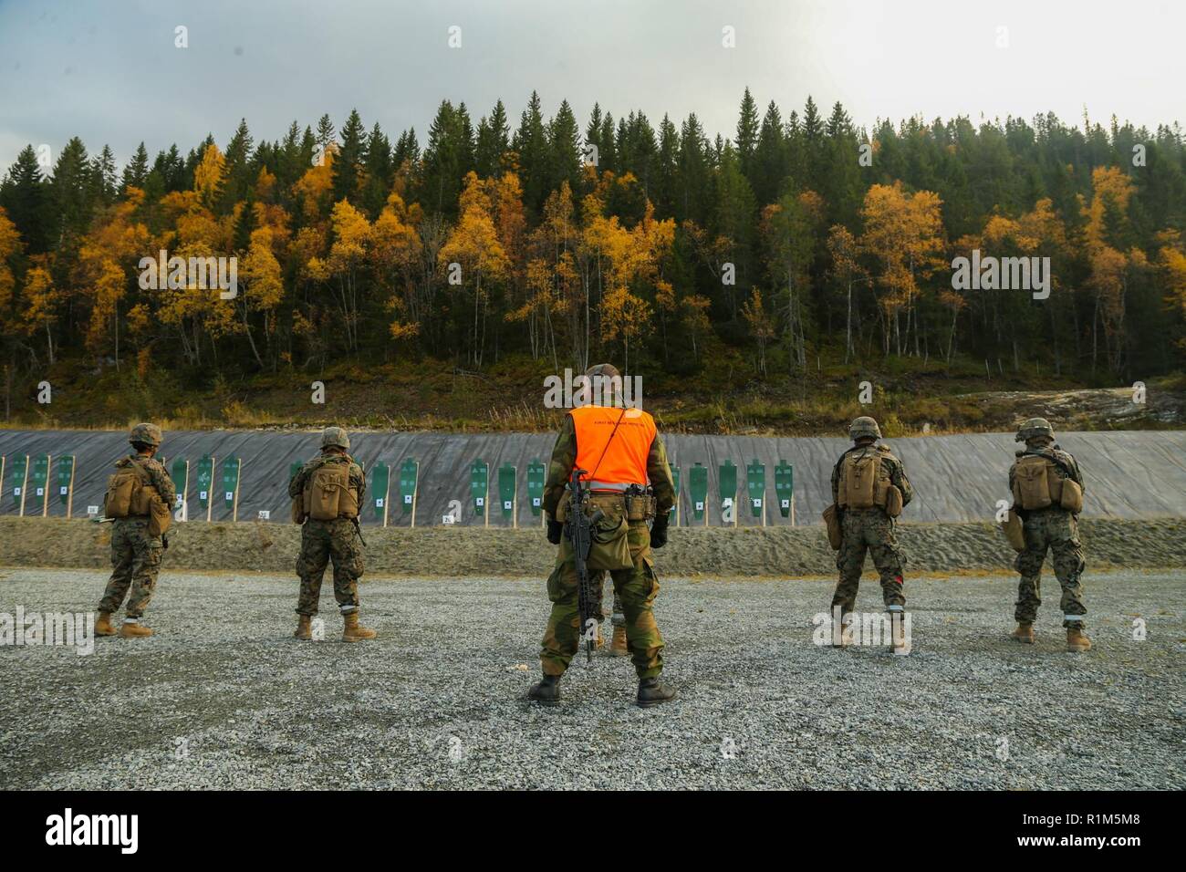 The Norwegian Home Guard trains U.S. Marines with 2nd Marine Logistics Group-Forward on different rifles used by the Norwegians during Exercise Trident Juncture 18 in Hell, Norway, Oct. 12, 2018. The Norwegians trained U.S. Marines on the familiarization of different rifles used by the Norwegians to enhance the U.S. and NATO Allies' and partners' ability to work together collectively to conduct military operations under challenging conditions. Stock Photo