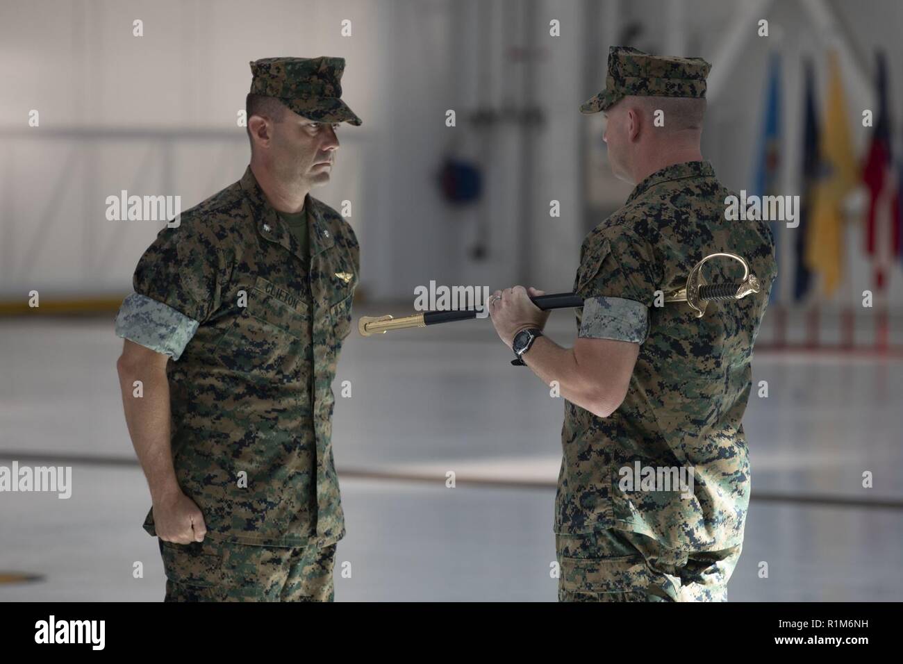 U.S. Marine Corps Lt. Col. Brian Clifton, commanding officer, Marine Medium Tiltrotor Squadron (VMM) 363, prepares to pass on a non-commissioned officer sword during an appointment ceremony for Sgt. Maj. Phillip Anderson, officially welcoming him to the squadron, Oct. 19, 2018. VMM-363, nicknamed the Lucky Red Lions, arrived to Hawaii earlier this year increasing the combat capability and crisis response within the Indo-Pacific region. Stock Photo