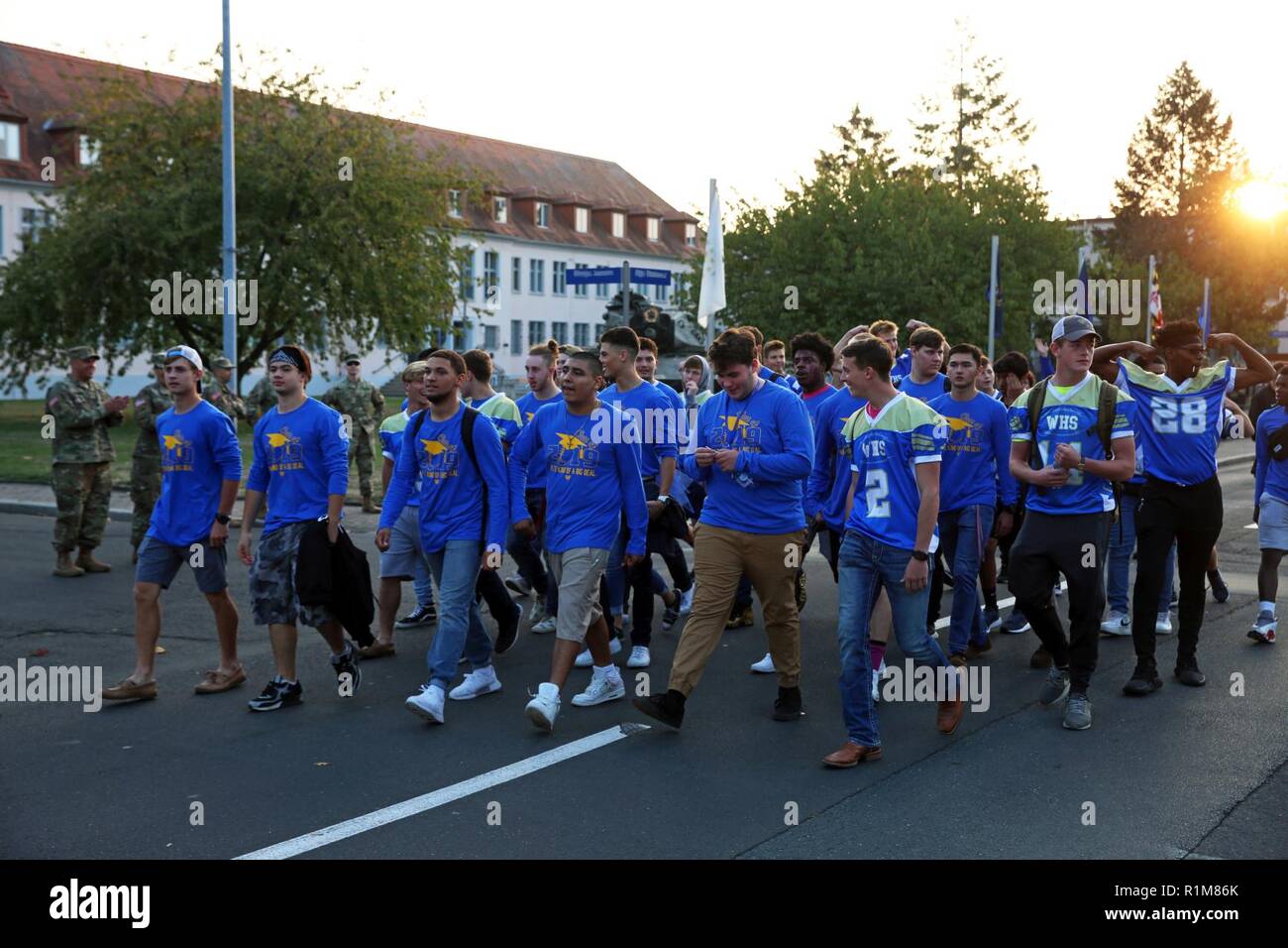 Students from the Wiesbaden High School football team march in the