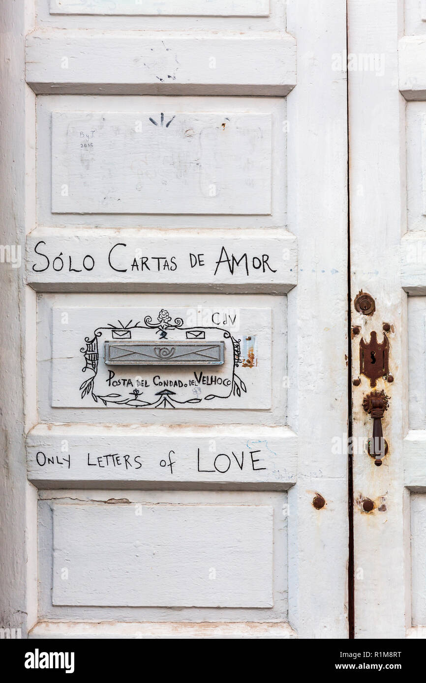 Letterbox detail on front door with writing saying only letters of love, solo cartas de amor, in Spanish and English languages, in Santa Cruz de La Pa Stock Photo