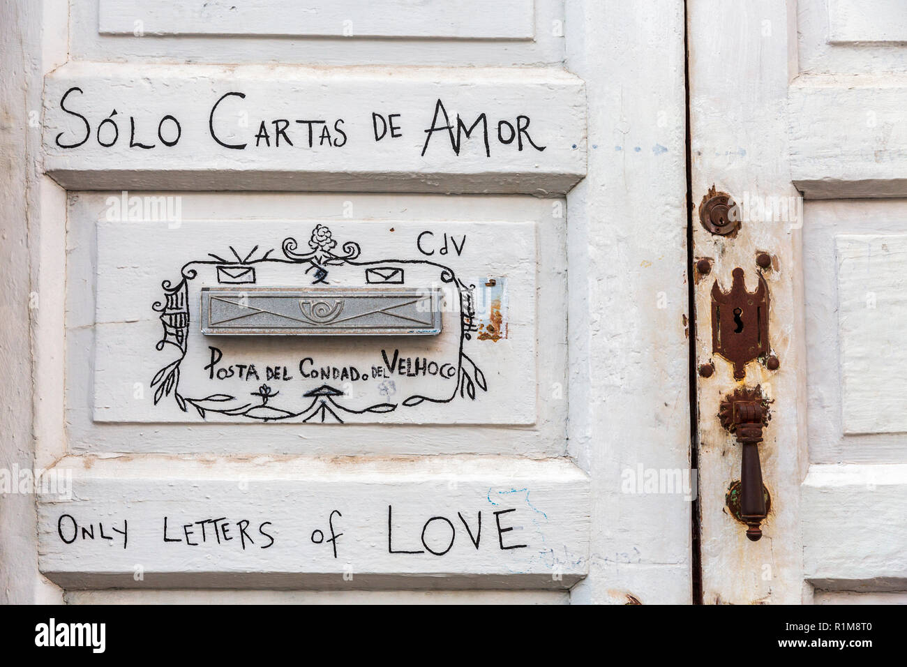 Letterbox detail on front door with writing saying only letters of love, solo cartas de amor, in Spanish and English languages, in Santa Cruz de La Pa Stock Photo