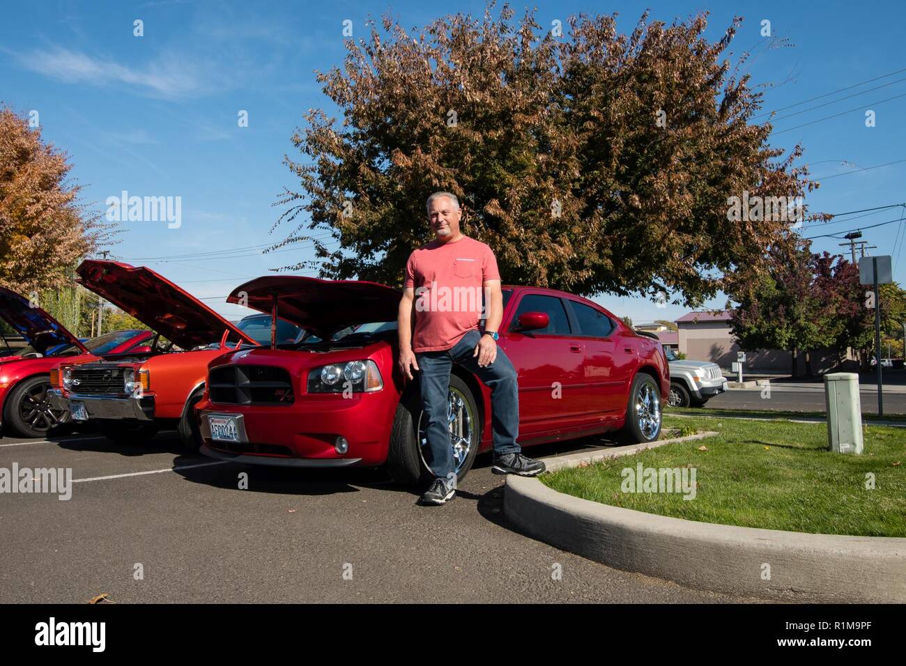 Michael (Mike) Deccio, an engineering technician, stands with his Inferno Red 2006 Dodge, Charger that was one of the first in the assembly line. Mike is one of the 15 U.S. Army Corps of Engineers Walla Walla District employees who participated in the “Wheels to Work” day, on October 19, 2018, in Walla Walla, Washington. Stock Photo