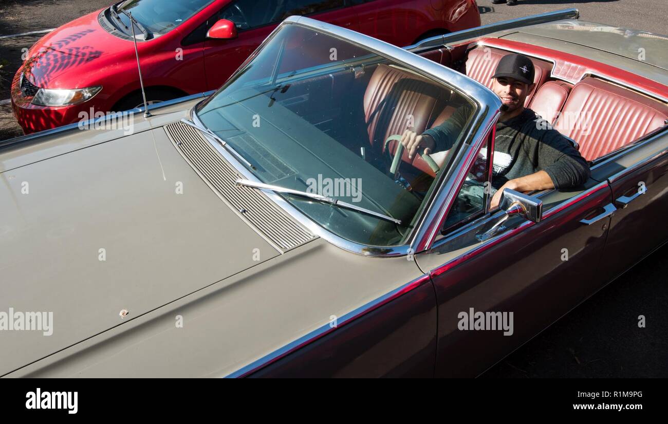 Mechanical engineer, Sergio Sanchez shows off his newly purchased Navajo Beige 1964 Lincoln, Continental Convertible. Sergio was one of the 15 U.S. Army Corps of Engineers Walla Walla District employees who participated in the “Wheels to Work” day, on October 19, 2018, in Walla Walla, Washington. Stock Photo