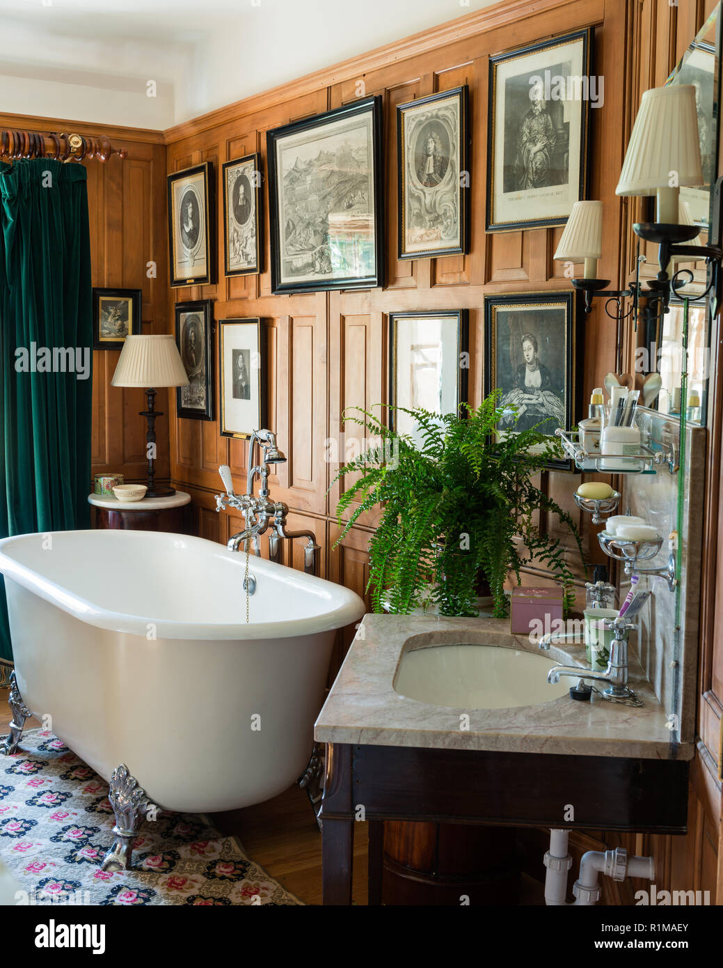 Claw foot bathtub in wood panelled bathroom Stock Photo