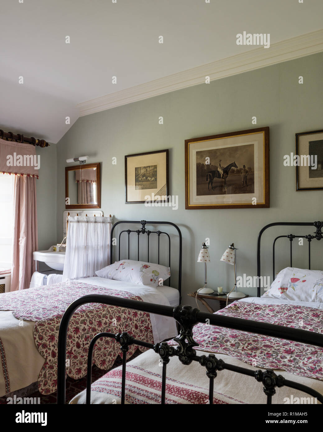Matching single beds in Edwardian style bedroom Stock Photo
