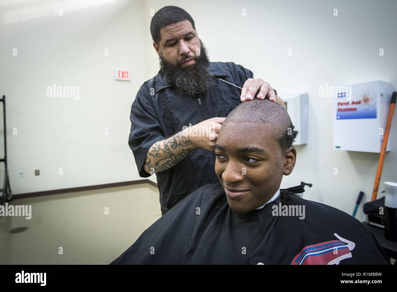 A New Jersey Youth ChalleNGe Academy Class 49 candidate has his hair cut  during in-processing at the Joint Military and Family Assistance Center at  the National Guard Armory in Bordentown, ., Oct.