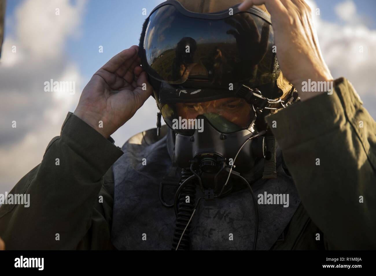 U.S. Marine Corps Gunnery Sgt. Todd Bauer, a crew chief with Marine Heavy Helicopter Squadron 463, Marine Aircraft Group 24, dawns his gas mask during Chemical, Biological, Radiological, Nuclear Environment (CBRNE) helicopter support training, Marine Corps Air Station Kaneohe Bay, Oct. 22, 2018. The CBRN operations are conducted to aid in producing readiness within the squadron. Stock Photo