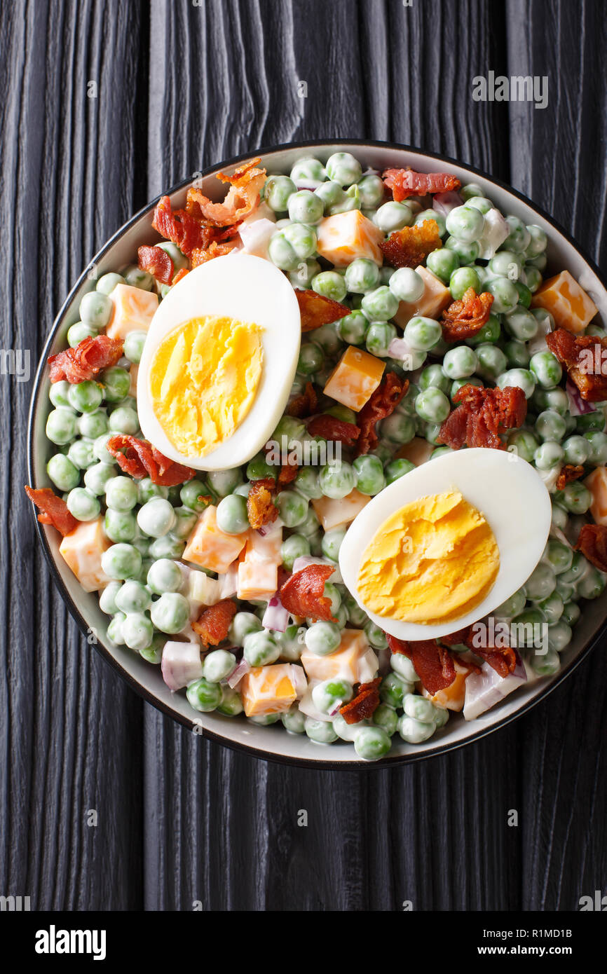 English green pea salad with boiled eggs, onions, bacon and cheddar