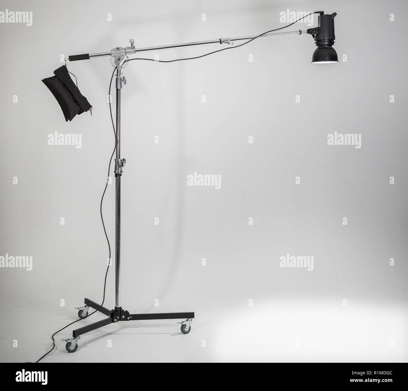 Studio light on a boom arm and stand in the studio. Stock Photo