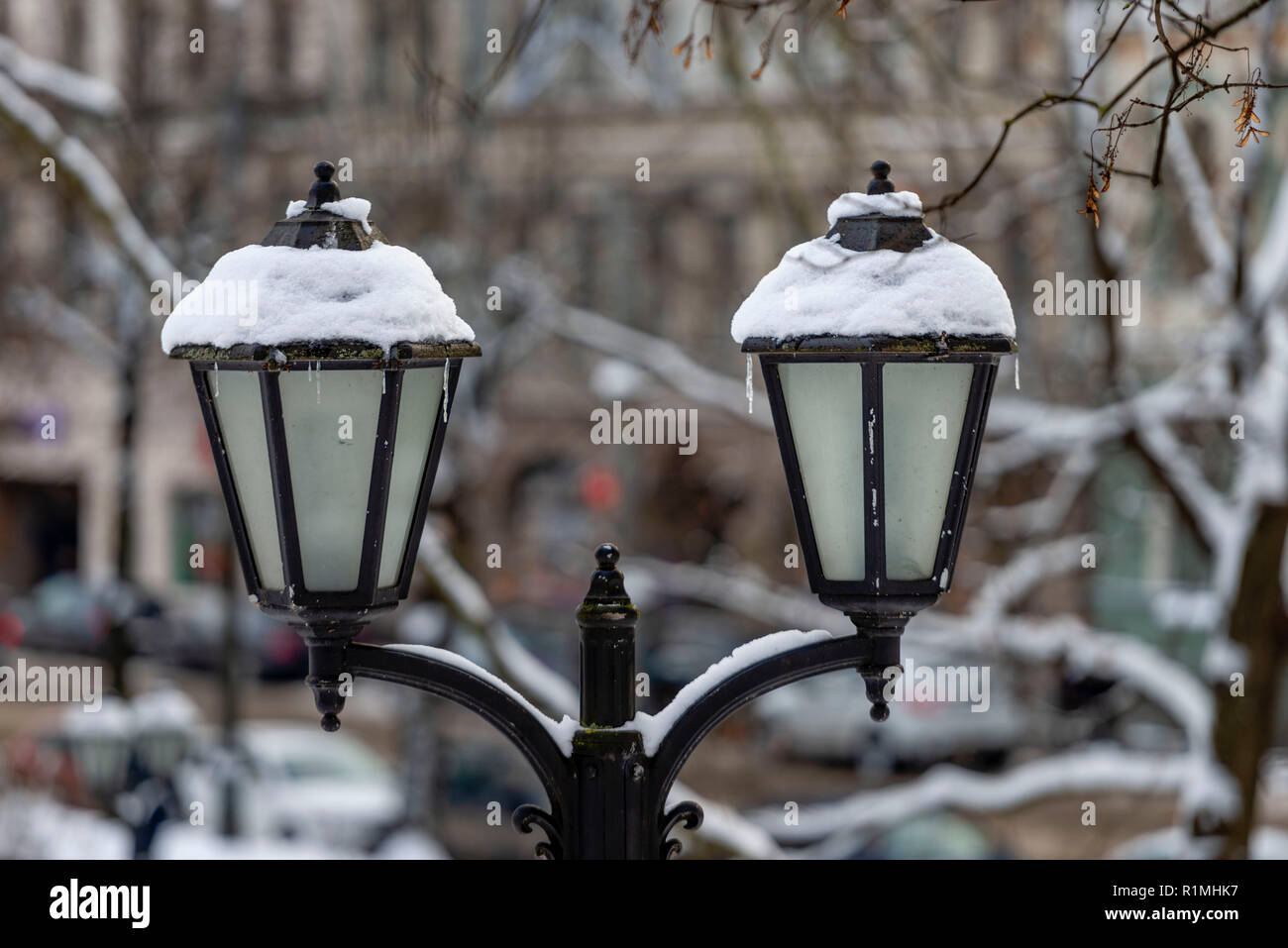 Snow-covered ancient lantern to the city park in the background Stock ...