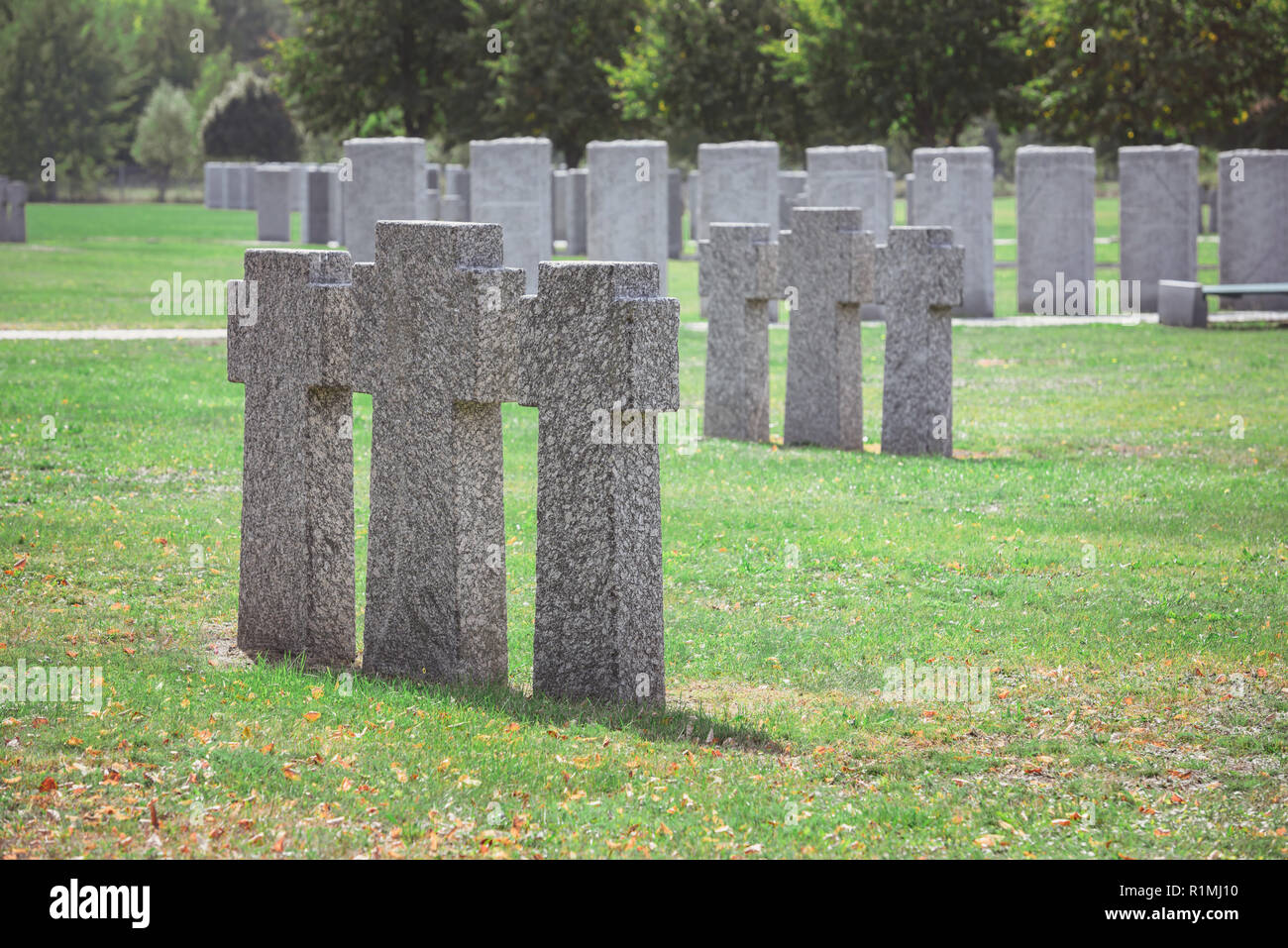 rows of identical old gravestones on grass at graveyard Stock Photo - Alamy