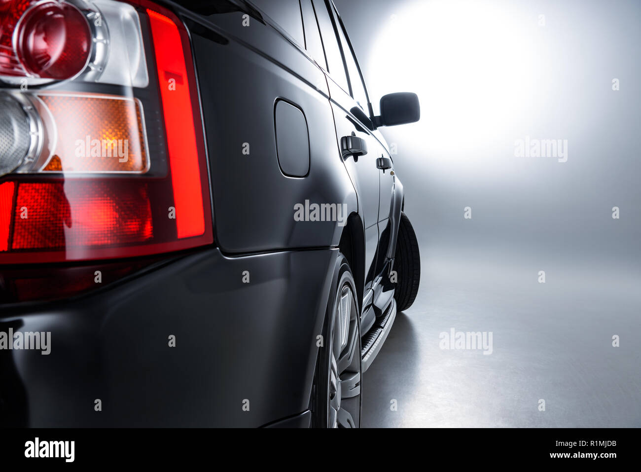 Close up view of rear headlight rear of luxury black car on grey ...
