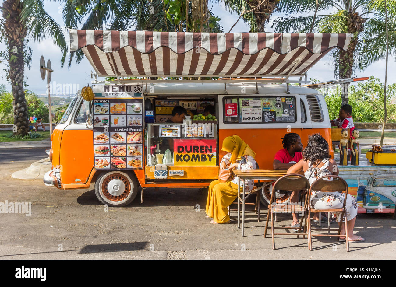 Food truck in a classic orange volkswagen van at the Garuda Wisnu Kencana Cultural Park Stock Photo
