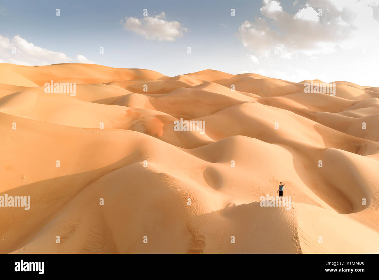aerial view of Liwa desert in Abu Dhabi and person standing in the dunes Stock Photo