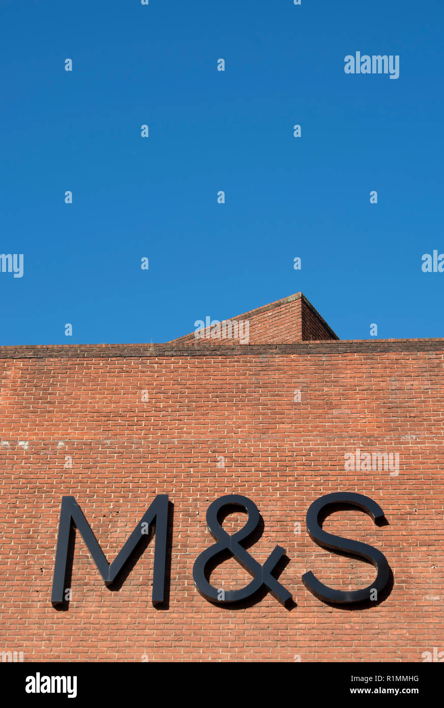 logo of marks and spencer on a brick wall behind one of the nationwide