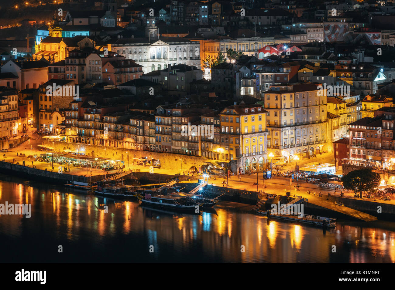 Porto cityscape. Embankment Douro River with bars, restaurants and active nightlife at night