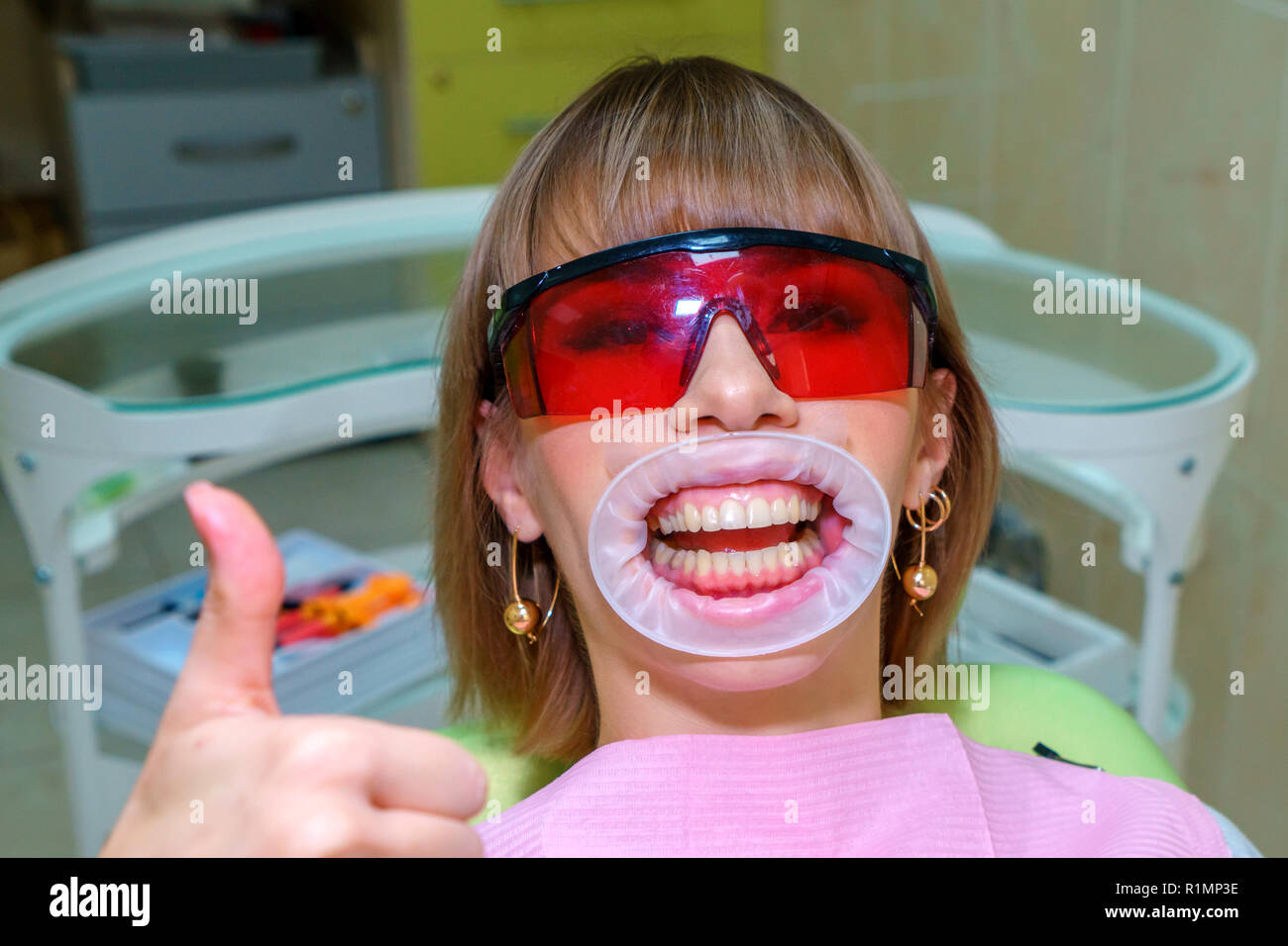 dentistry happy patient in the chair in goggles. Stock Photo