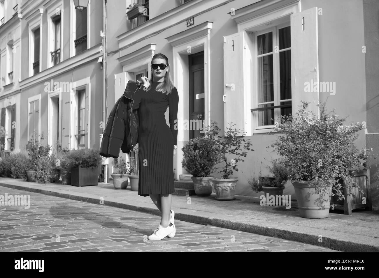 Woman total red outfit enjoy walk beautiful street Paris. Parisian