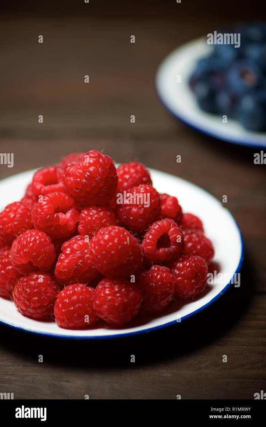 One Raspberry On A Table Close up of a raspberries group on a wood table Stock Photo - Alamy