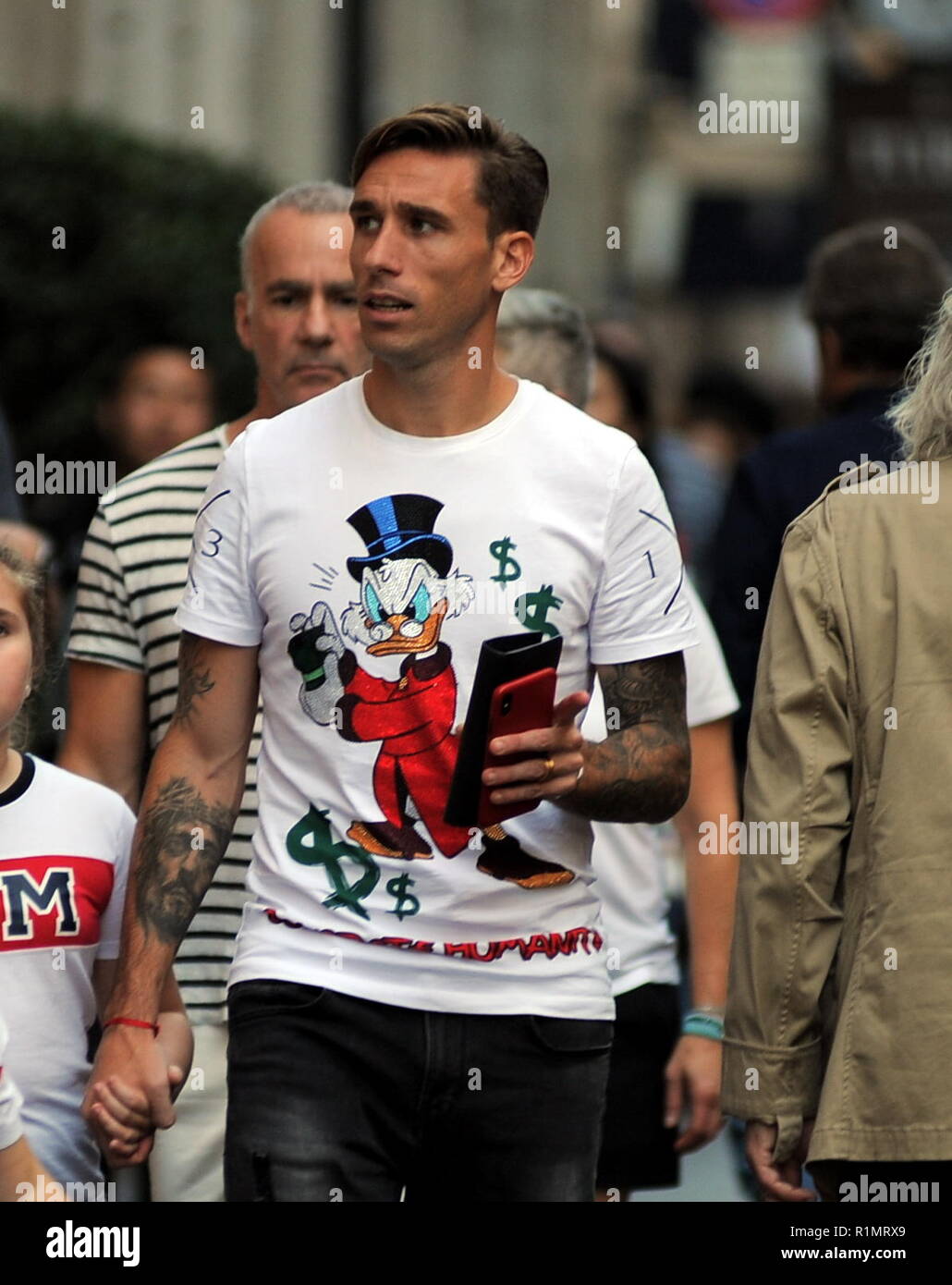Footballer Lucas Biglia of Milan and National Argentina walks through via Montenapoleone with his wife Cecilia Ambrosio and his kids Allegra and Alessio and then they stop at a cafe  Featuring: Lucas Biglia Where: Milan, Italy When: 13 Oct 2018 Credit: IPA/WENN.com  **Only available for publication in UK, USA, Germany, Austria, Switzerland** Stock Photo
