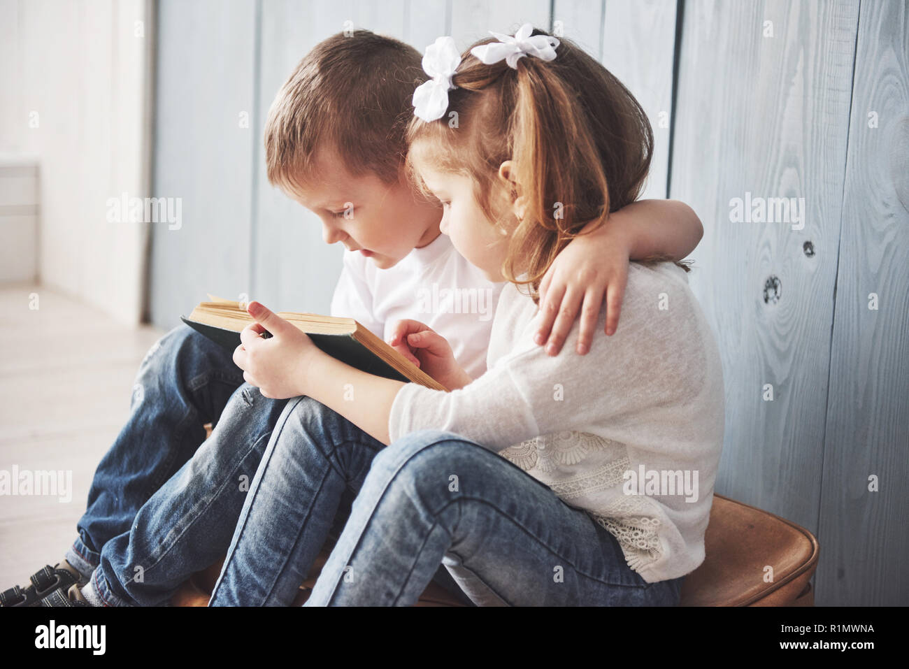 Ready to big travel. Happy little girl and boy reading interesting book ...