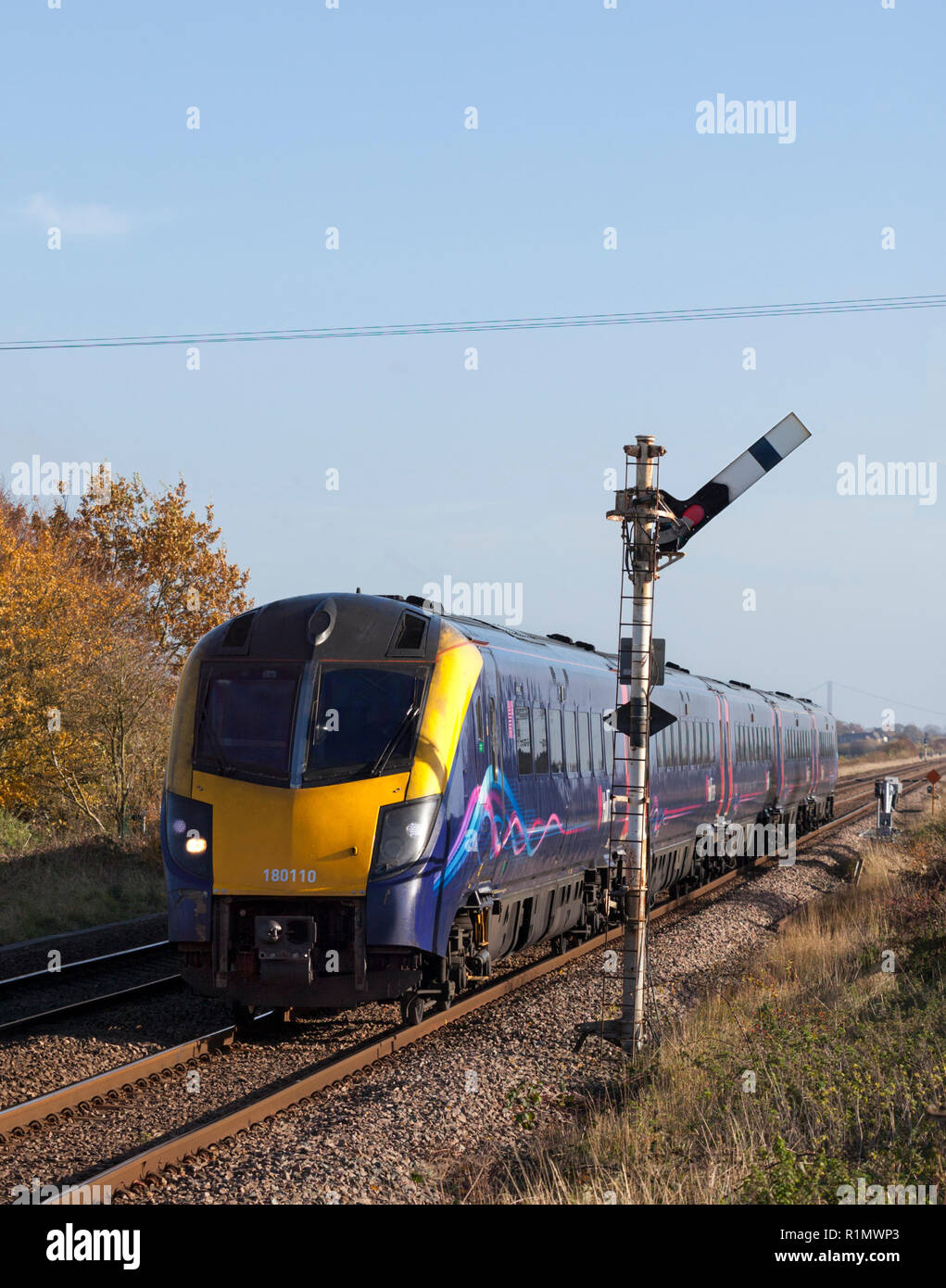 A First Hull Trains class 180 DMU train passing Crabley Creek on the line to Hull while running empty from Hull - Doncaster Stock Photo
