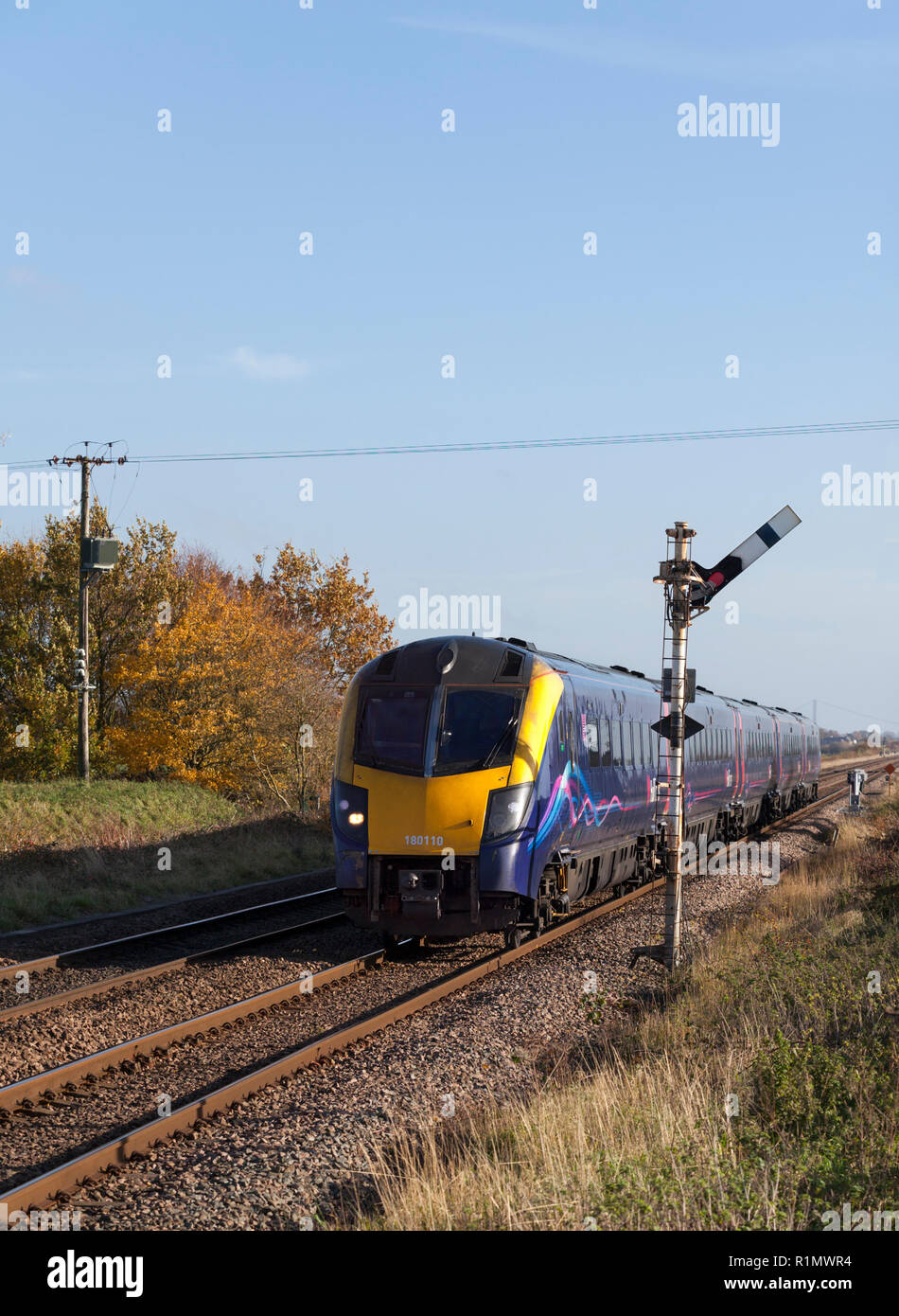 A First Hull Trains class 180 DMU train passing Crabley Creek on the line to Hull while running empty from Hull - Doncaster Stock Photo