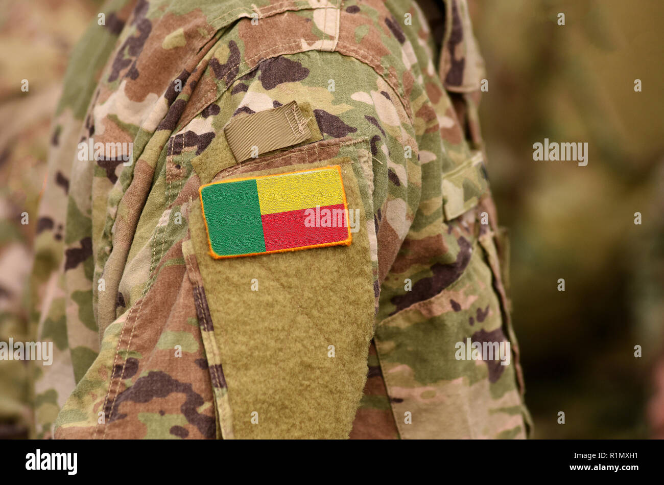 Benin flag on soldiers arm. Republic of Benin troops (collage) Stock Photo