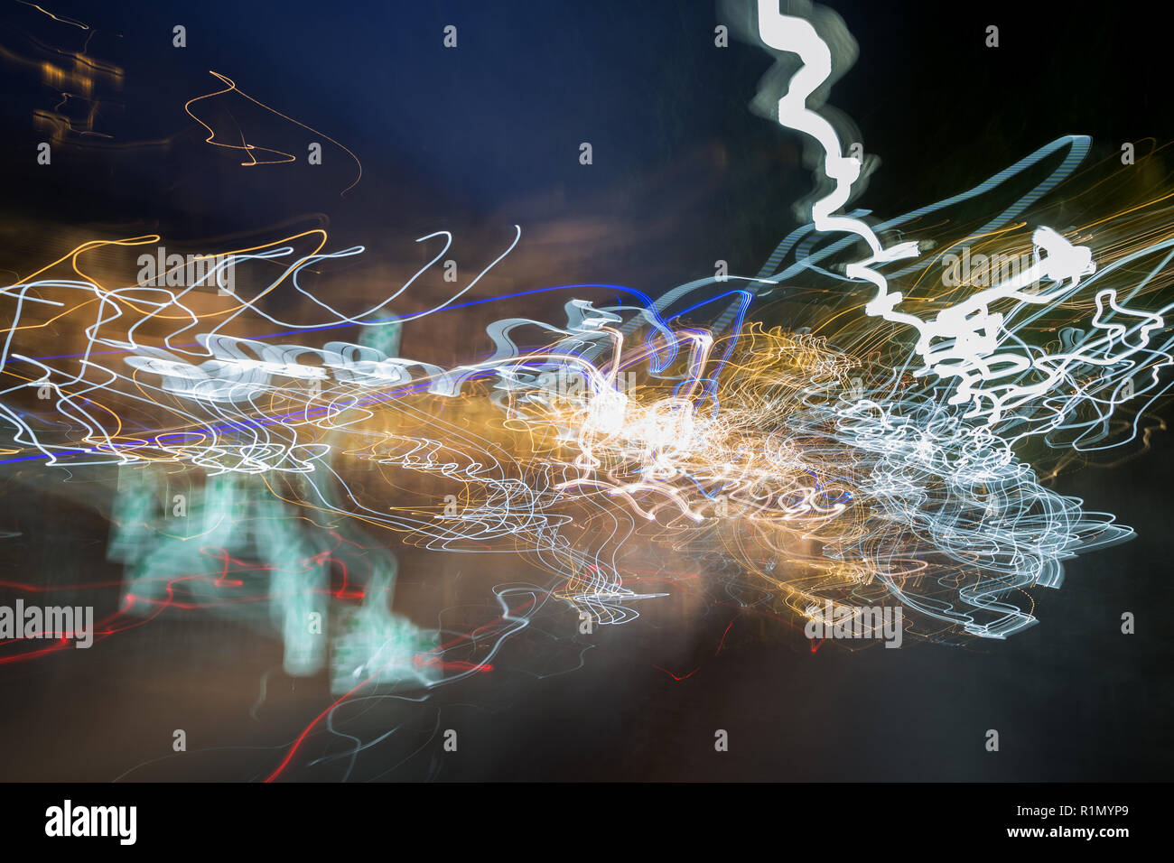 Abstract photo of motion and colorful light trails in a city at night ...