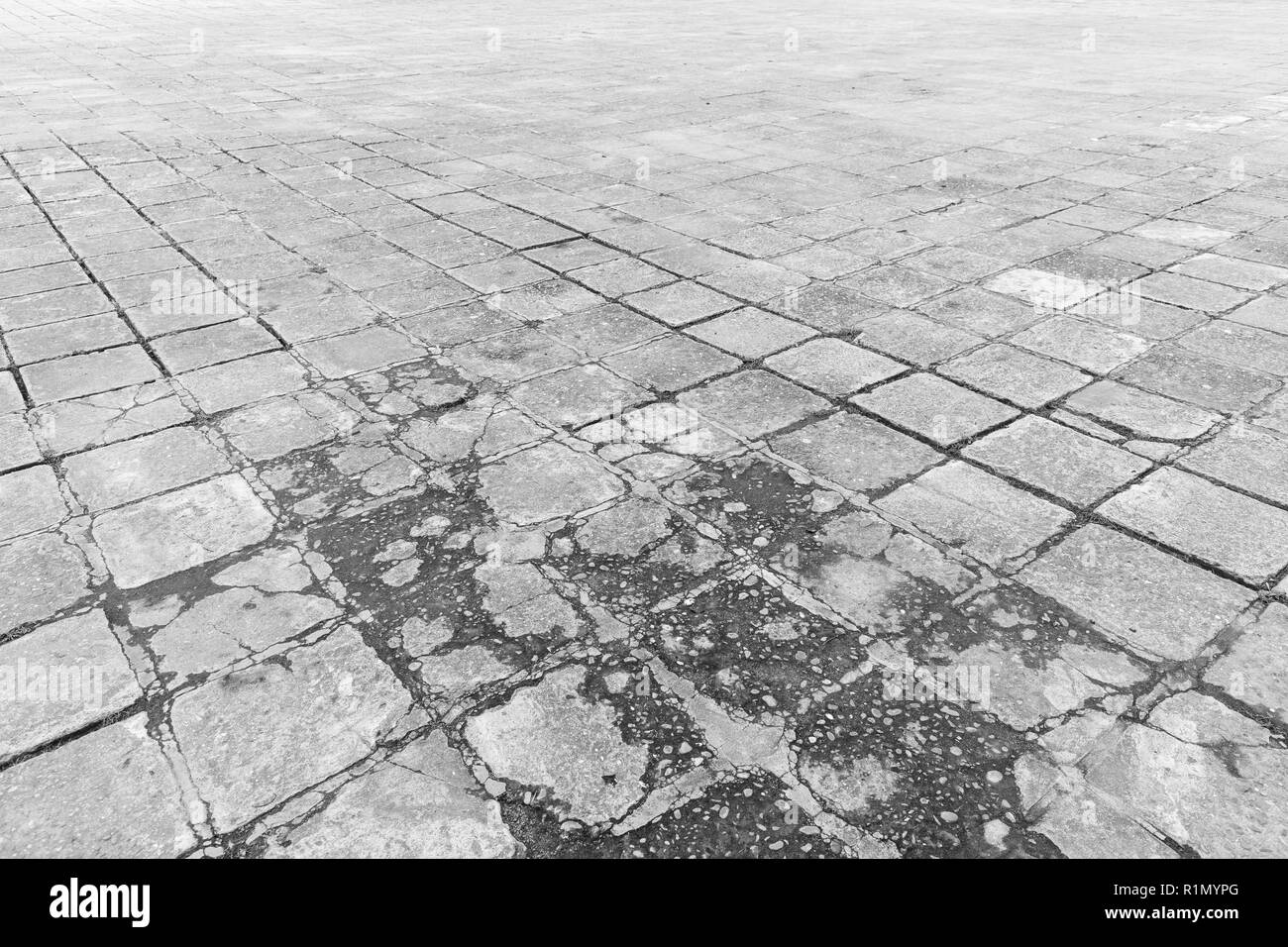 Full frame background of old and weathered cement paving slabs outdoors