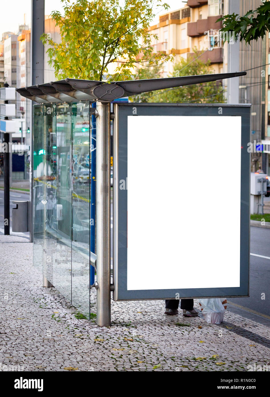 Vertical Bus Stop Advertisement Mockup. Street, Day. People Waiting. Copy Space. Stock Photo