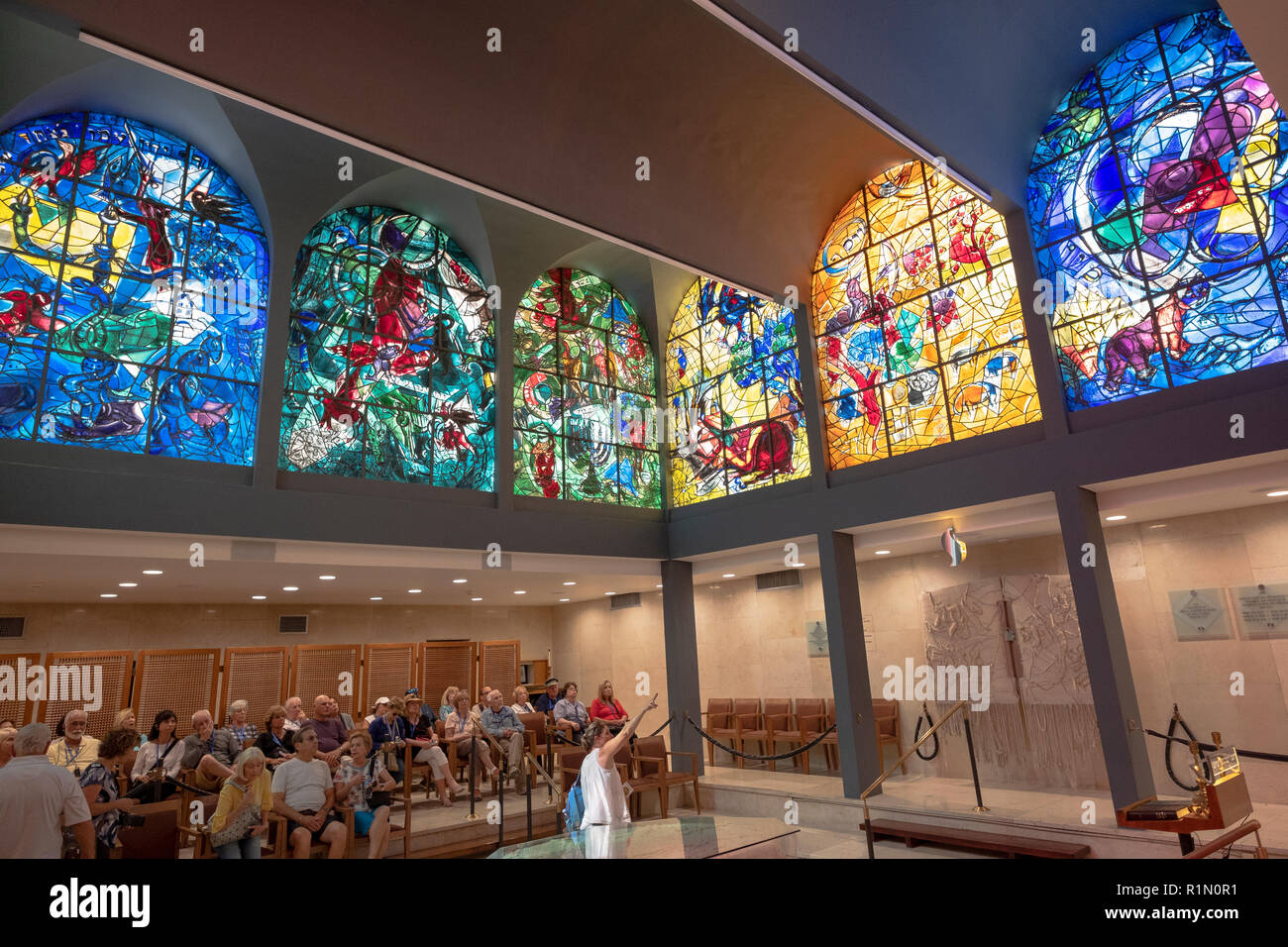 A tour group & lecturer viewing the Chagall Windows  at the Abbell Synagogue at the Hadassah University Medical Center in Jerusalem, Israel. Stock Photo