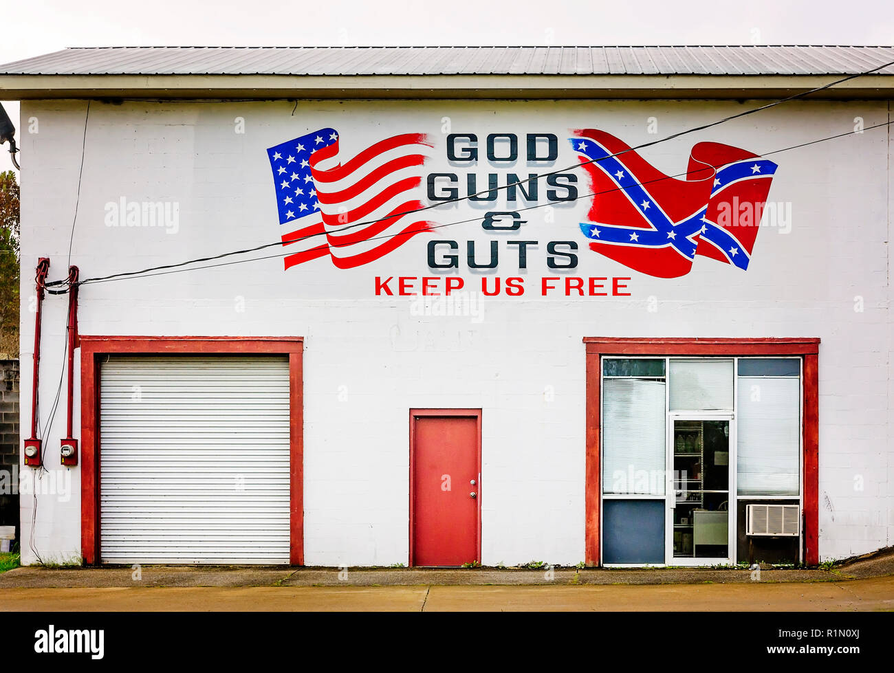 A business displays a mural with American and Confederate flags, and the phrase, “God Guns & Guts Keep Us Free,” Nov. 4, 2017, in Trenton, Georgia. Stock Photo