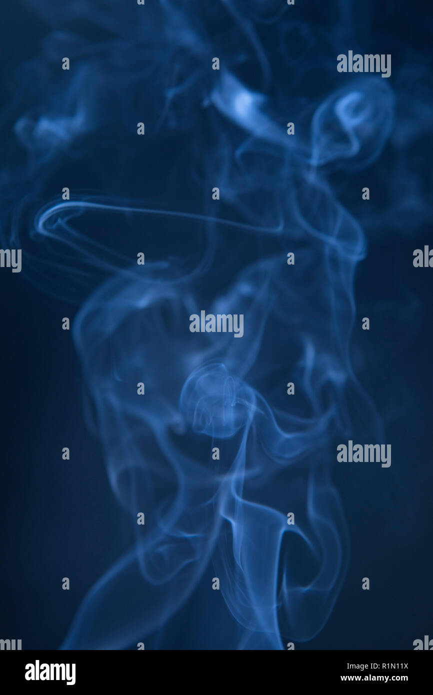 Abstract blue smoke swirls on dark background Stock Photo - Alamy