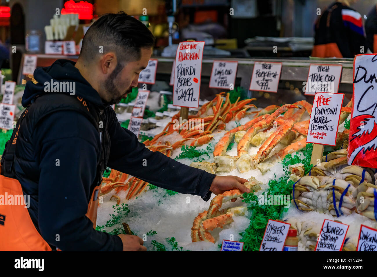 Seattle, United States - November 08, 2018: Fishmonger putting fresh