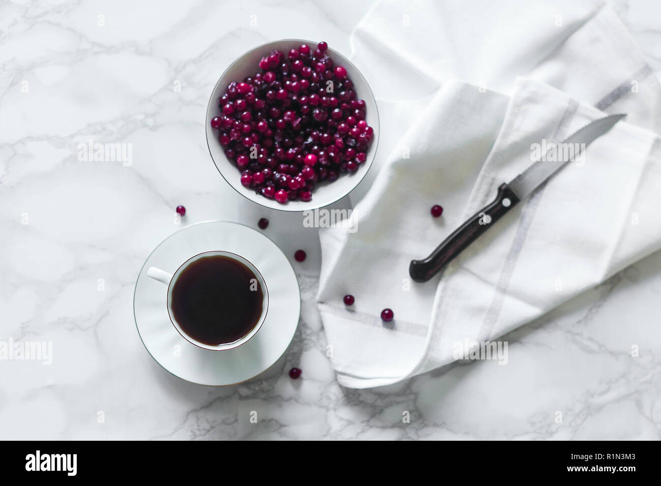 cranberry cowberry on marble background with cup Stock Photo